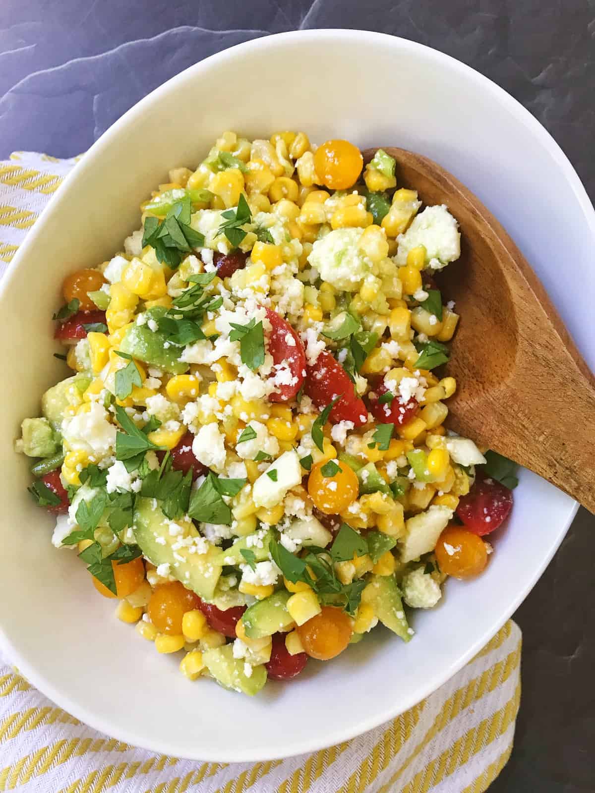 serving spoon in bowl of salad