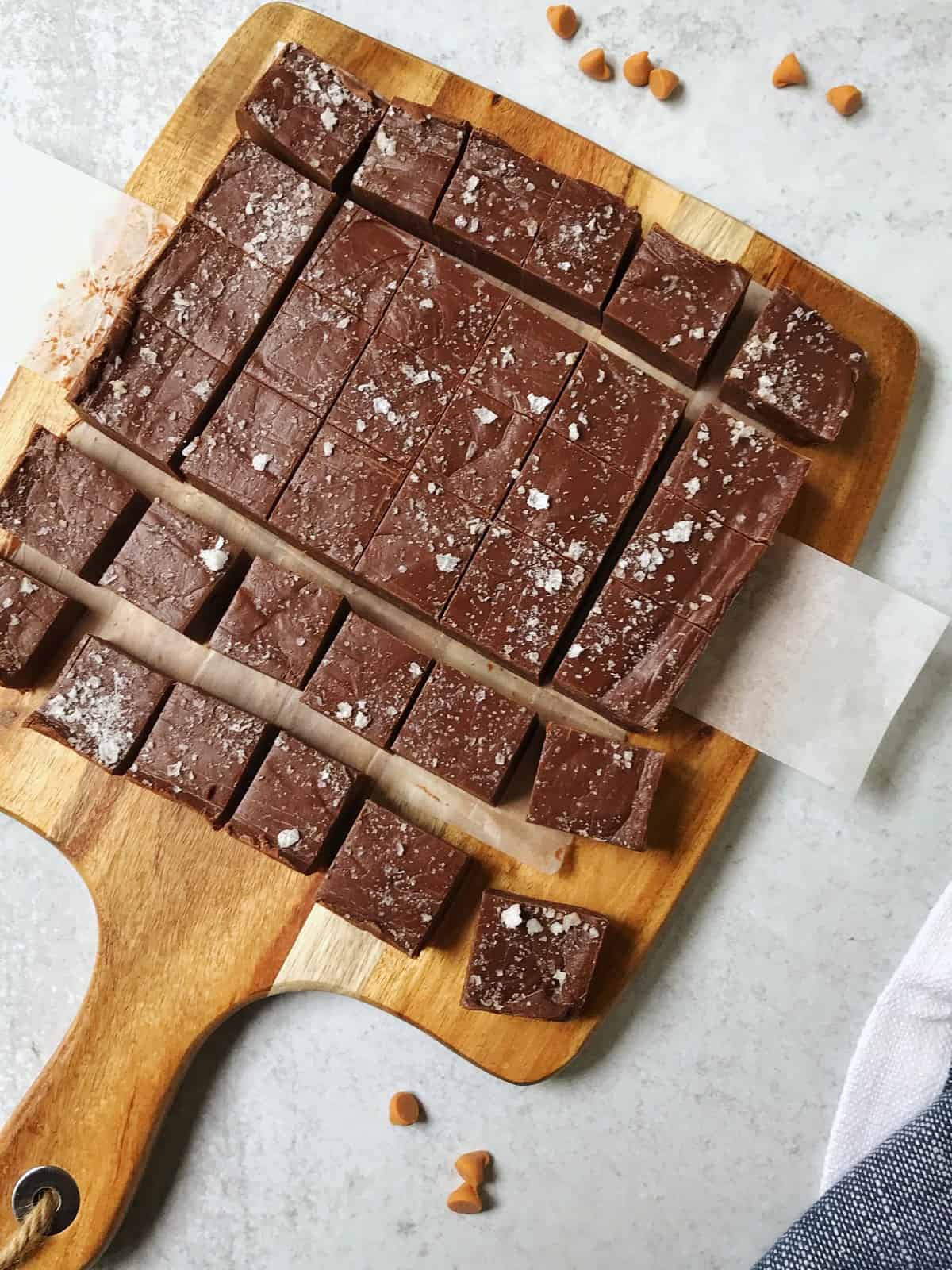 overhead shot of fudge sliced into squares on a cutting board