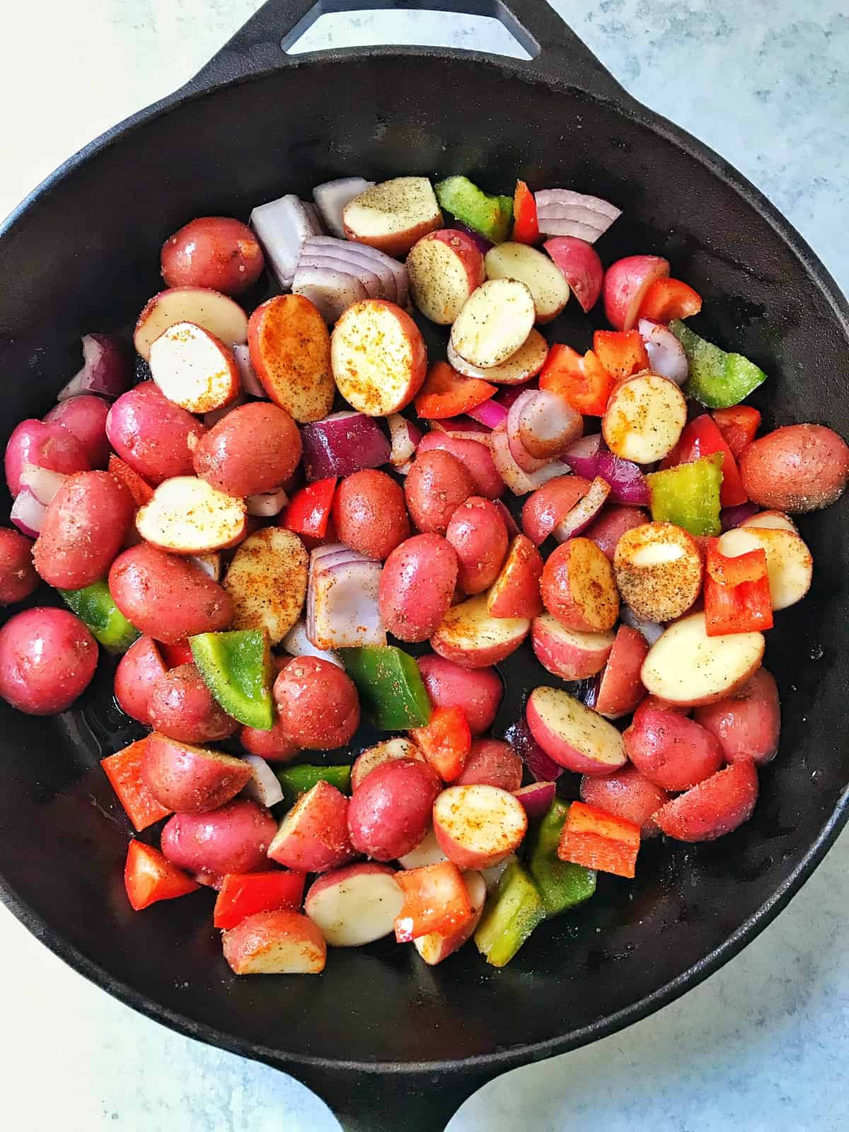 Potatoes, onions and peppers in skillet