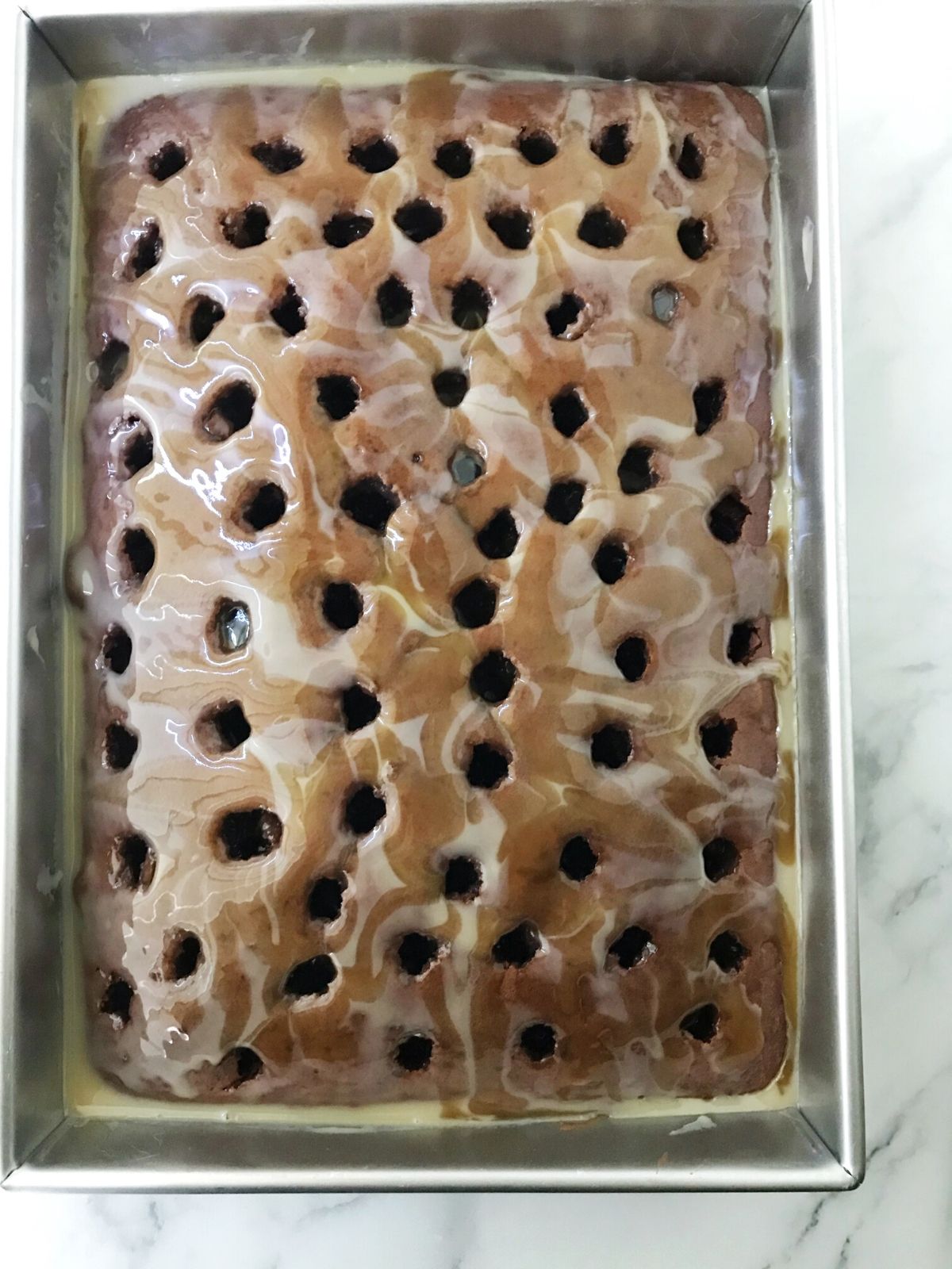 cake with holes topped with caramel mixture