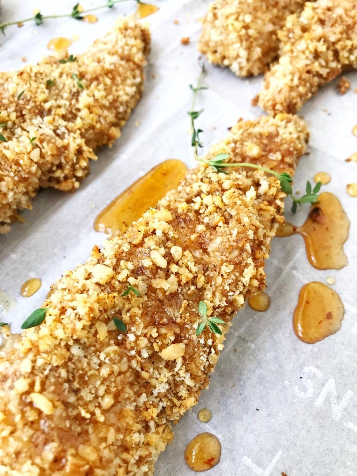 baked chicken strip with honey drizzle