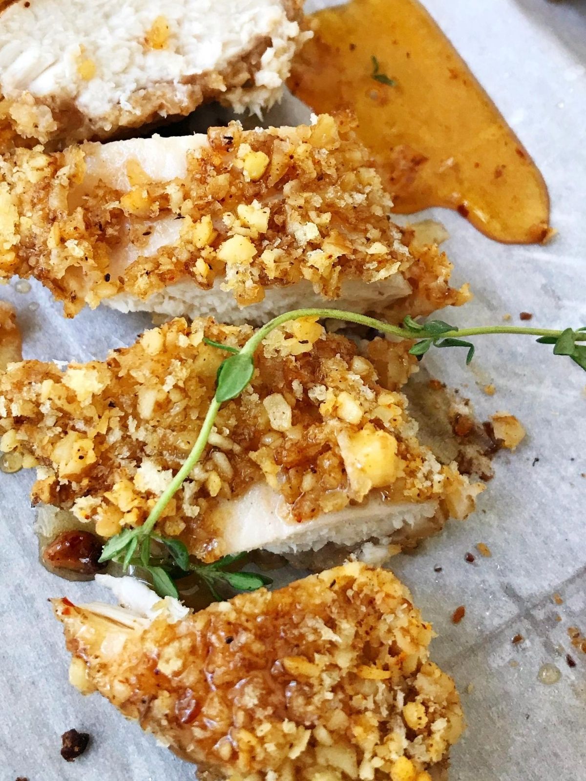 close up of sliced walnut chicken with honey