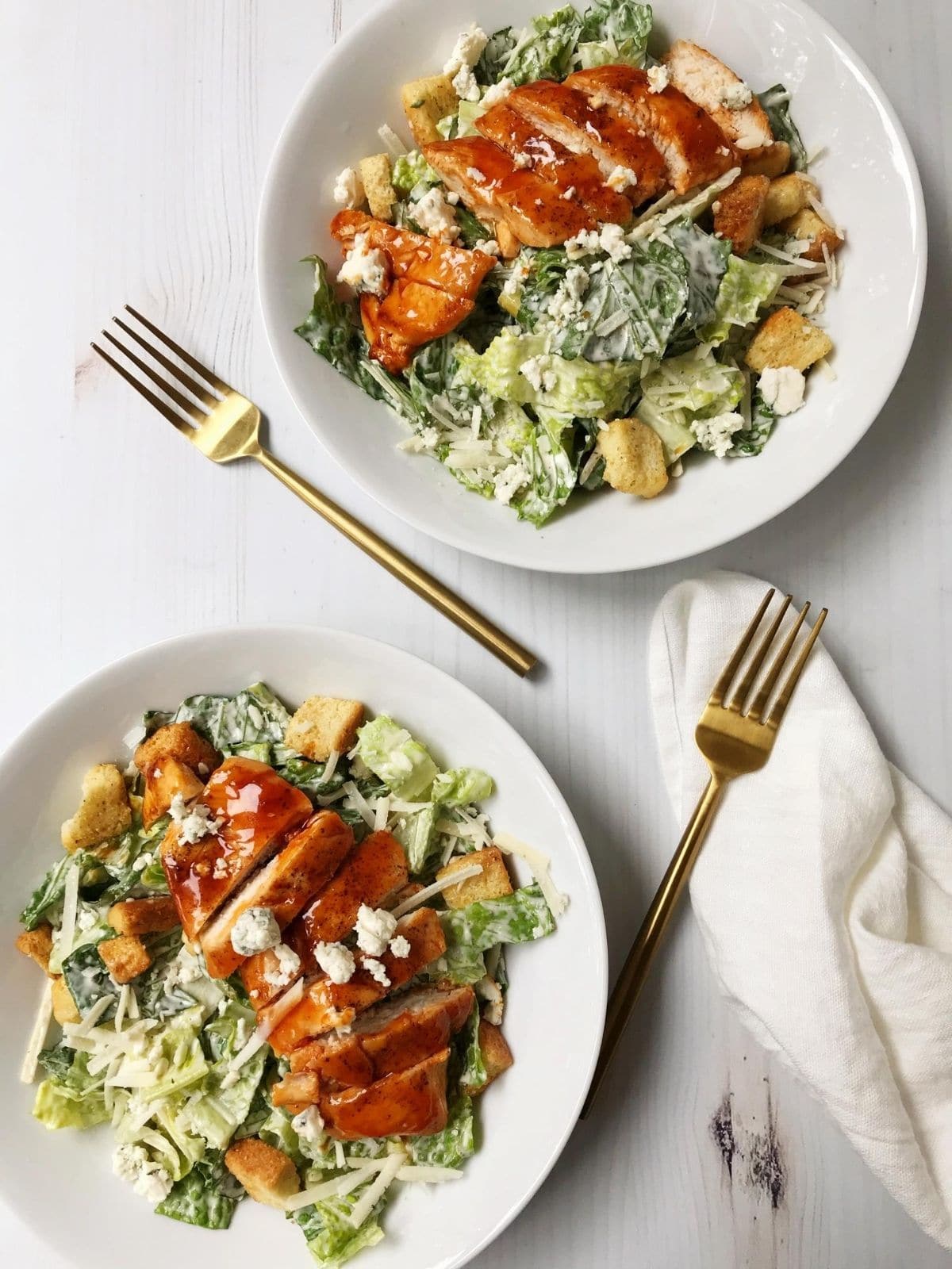 two bowls of salad with forks