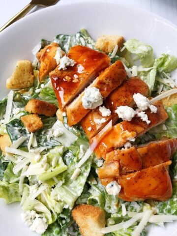 sliced chicken on top of salad