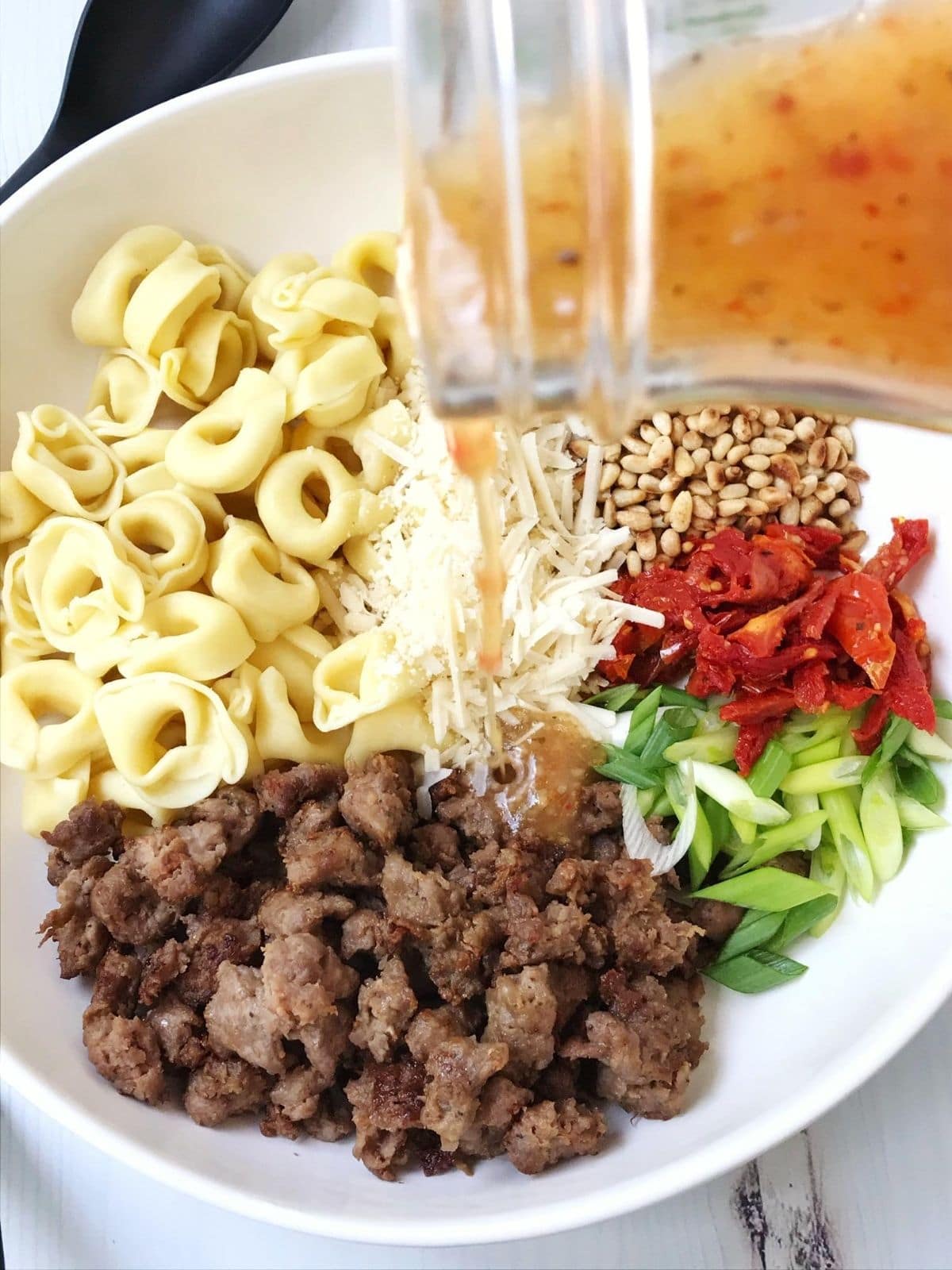 dressing poured over bowl of ingredients