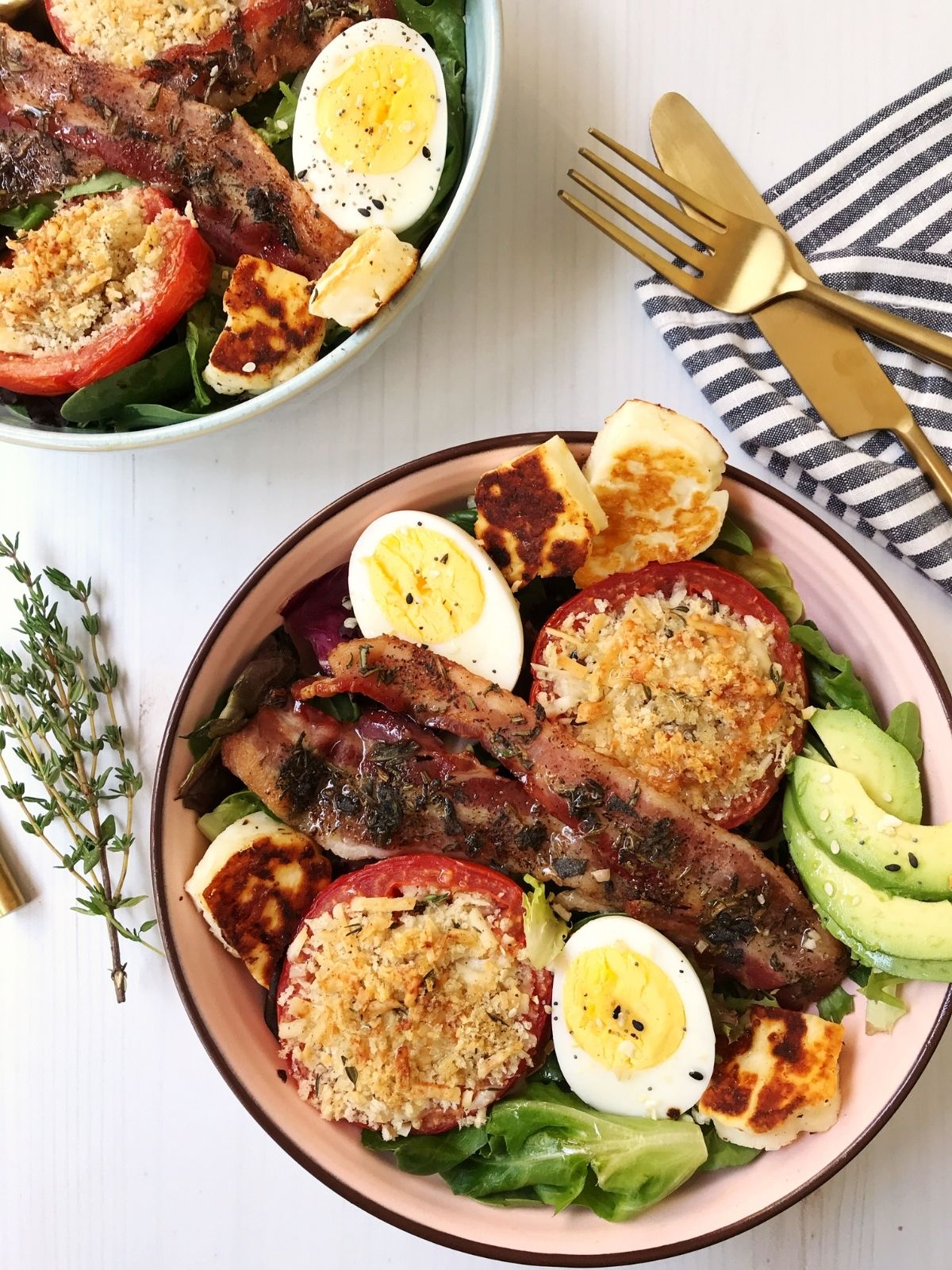 breakfast salad bowl with eggs, bacon, tomatoes, halloumi cheese