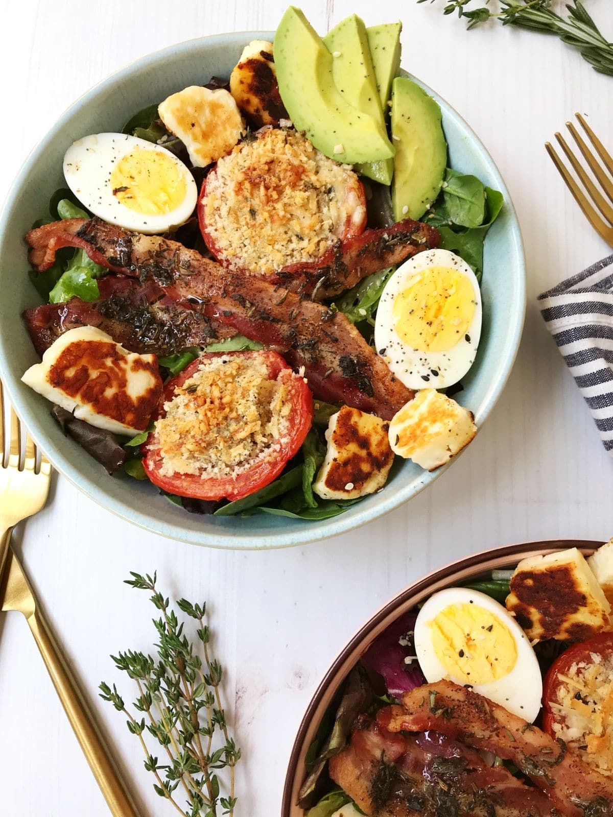 two bowls of breakfast salad with forks