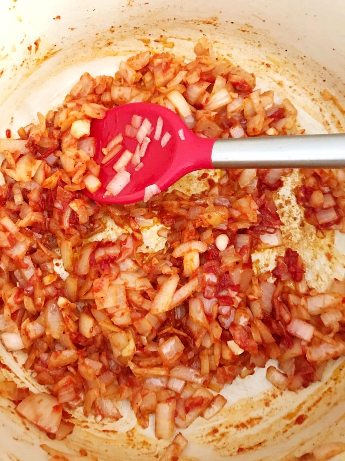 onions, garlic, and tomato paste in pot