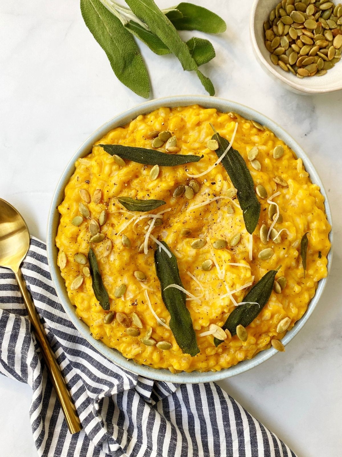 bowl of risotto garnished with sage leaves