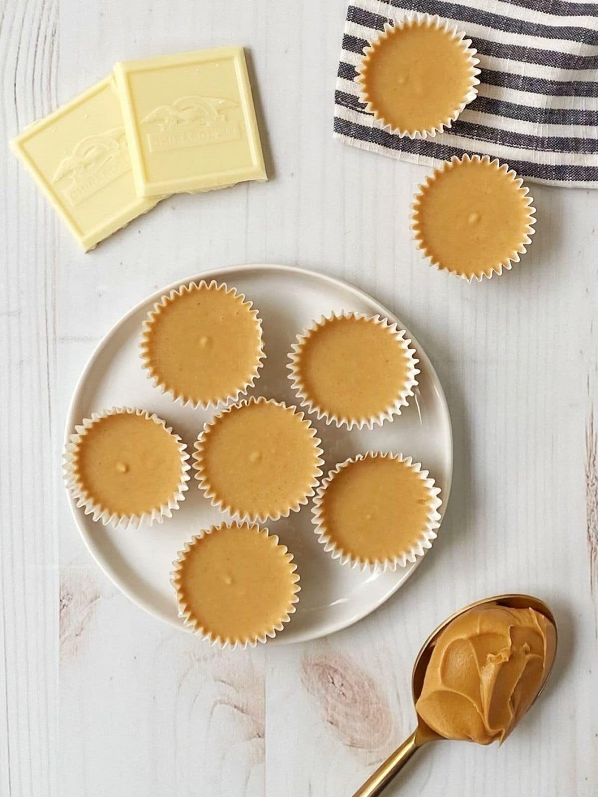 plate of peanut butter cups and spoonful of peanut butter