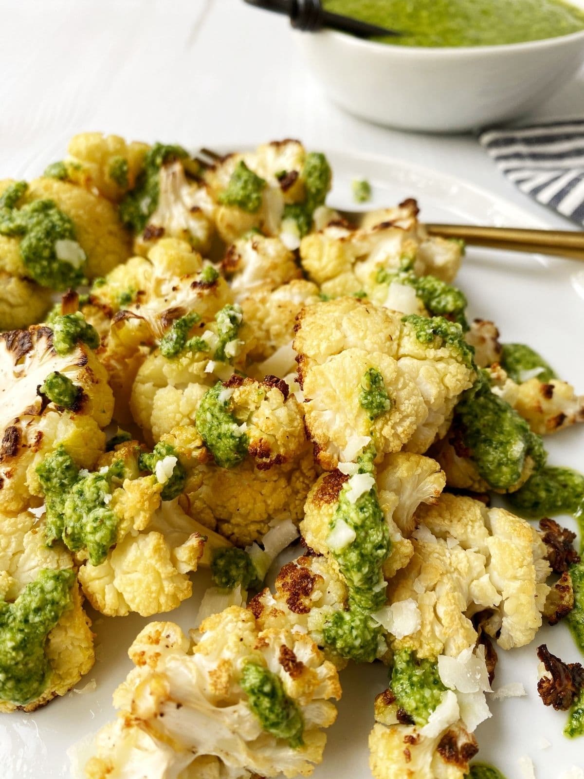 pesto topped cauliflower piled on a plate