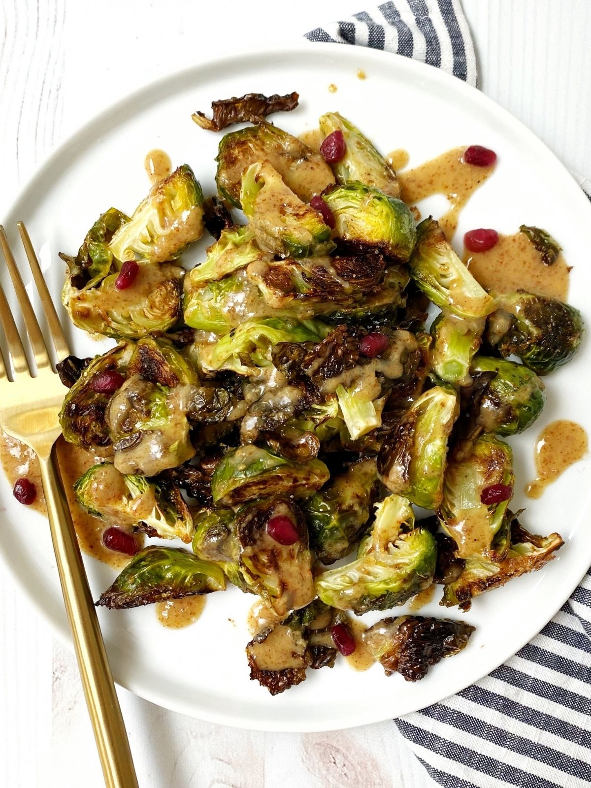 plate of roasted sprouts with a fork