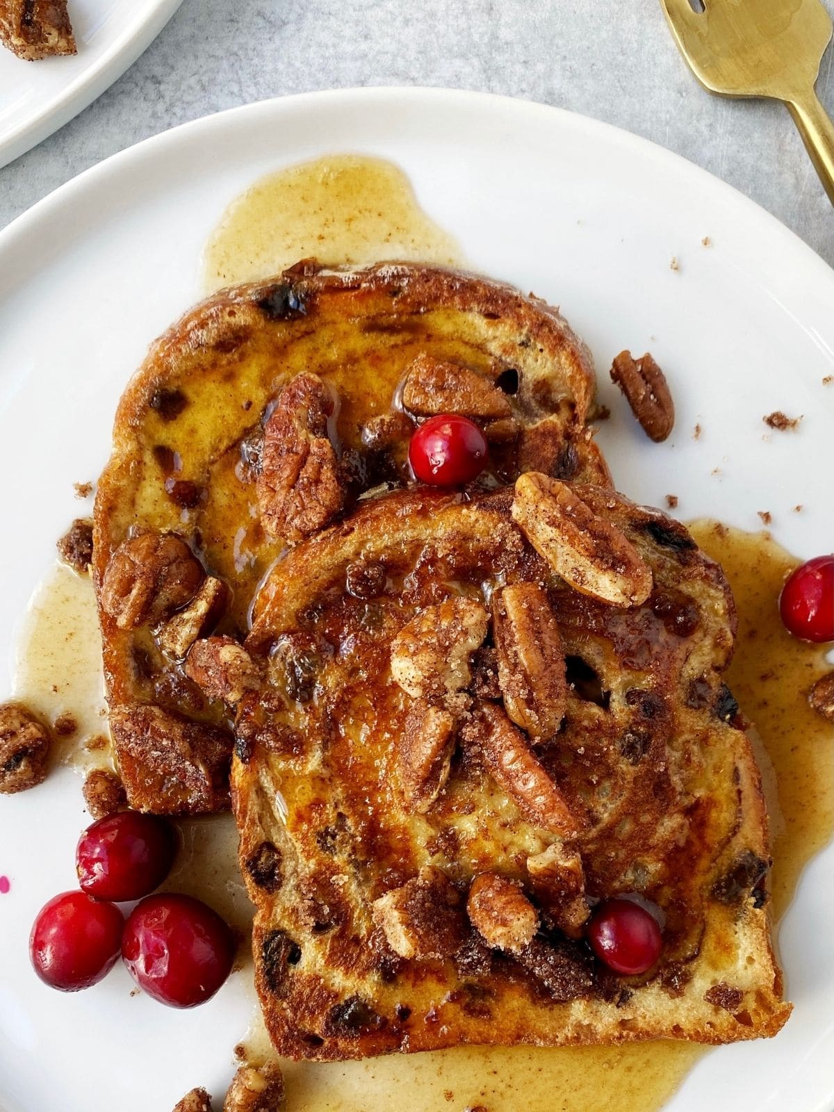 french toast covered with maple syrup and sprinkled with pecans