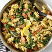 pan of pasta garnished with lemon