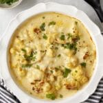 Baked cauliflower with cheese sauce in a baking dish.