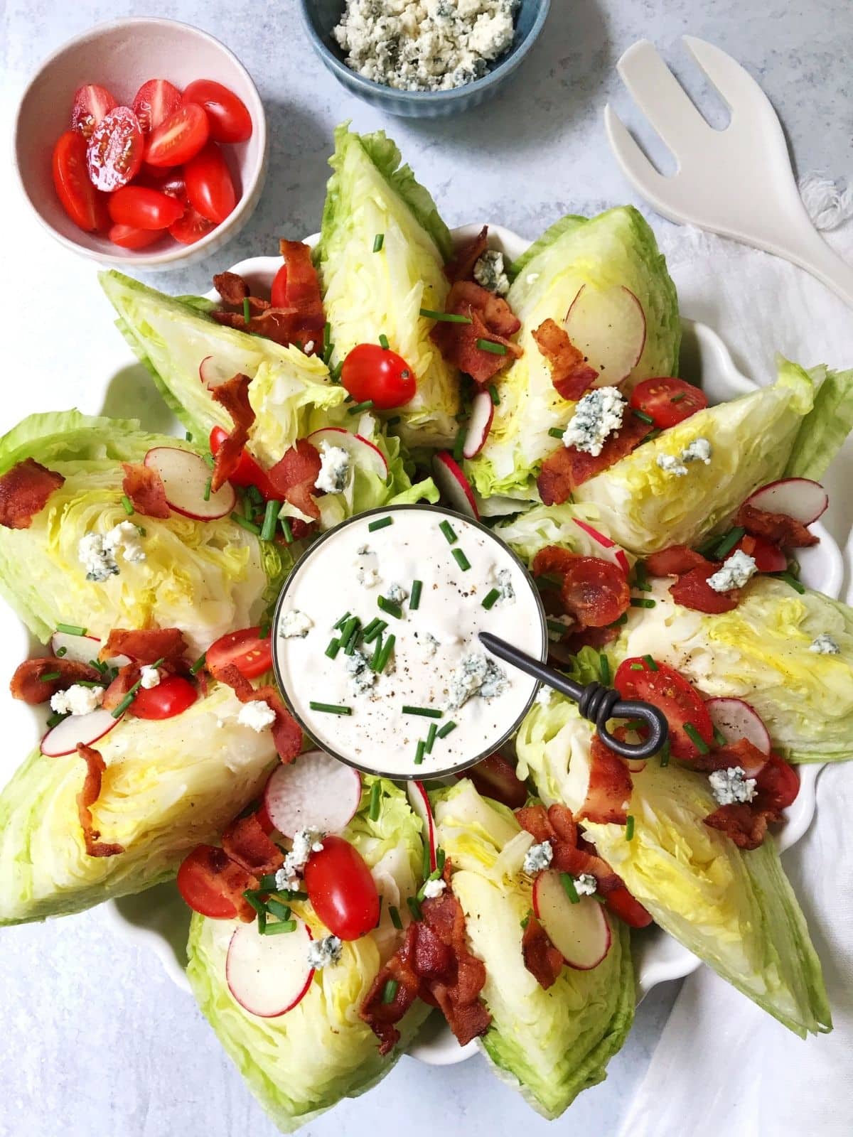 platter of wedge salad with bowl of dressing in the middle