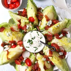 platter of lettuce wedges with dressing in the middle