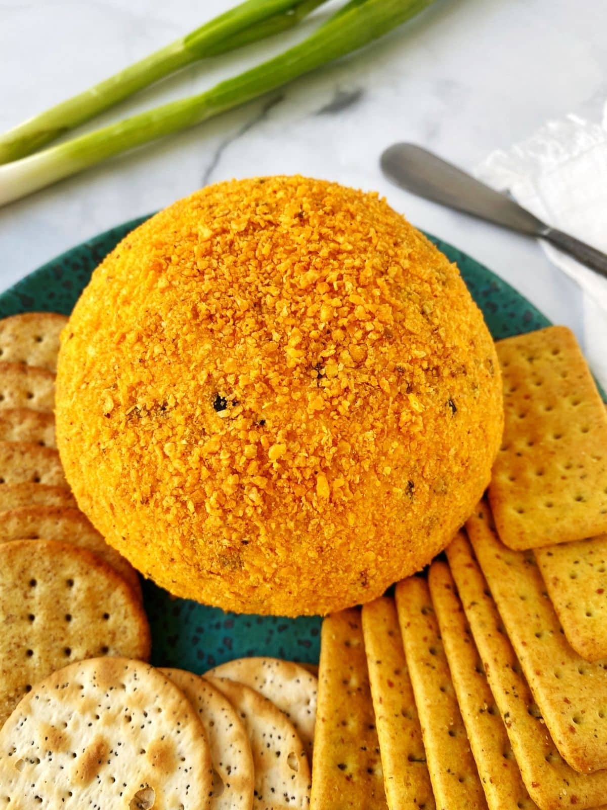 cheeseball on a platter with assorted crackers