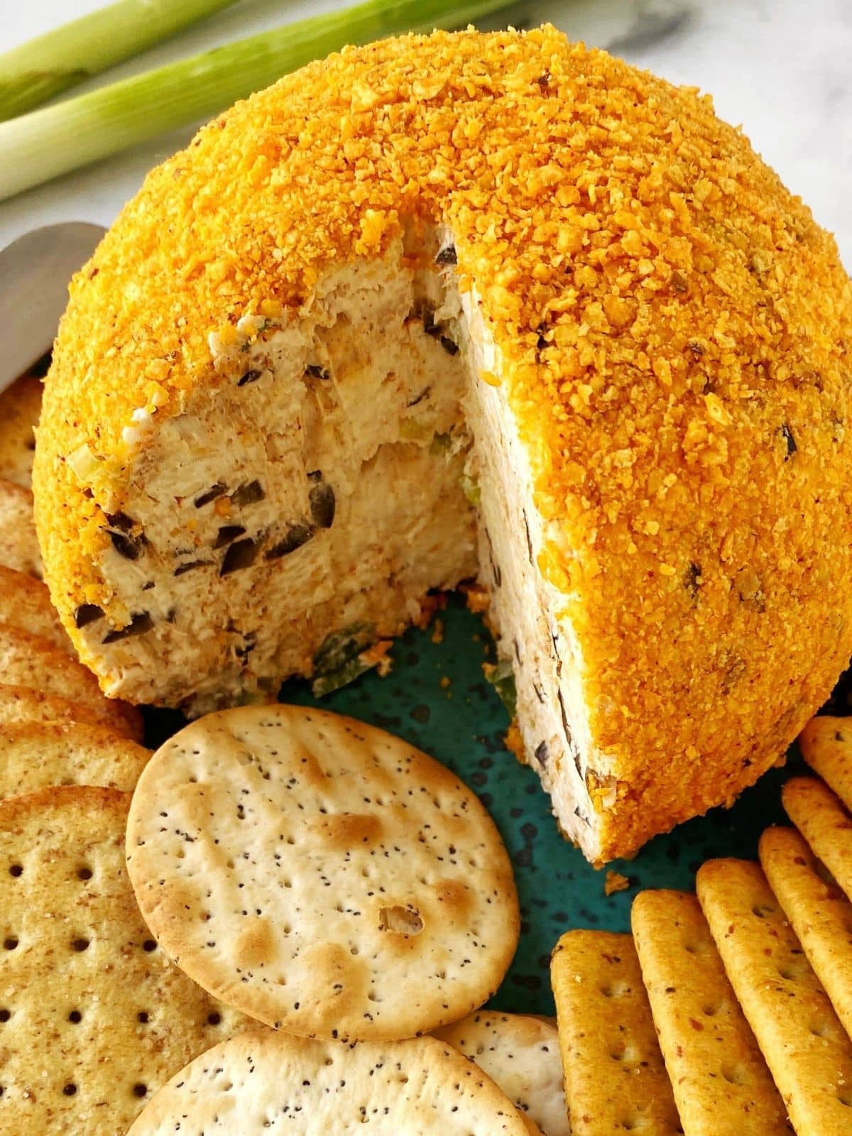 cheeseball with a cut wedge