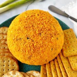 cheese ball on a platter with crackers