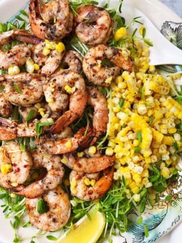 shrimp with grilled corn on a serving plate