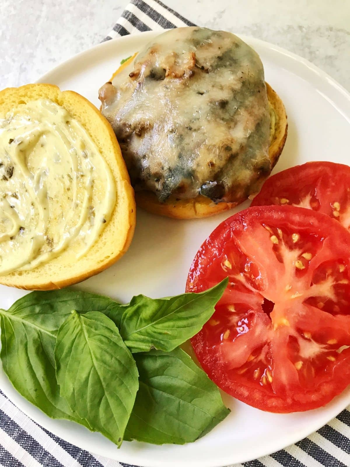 open-faced brger on a plate with fixings