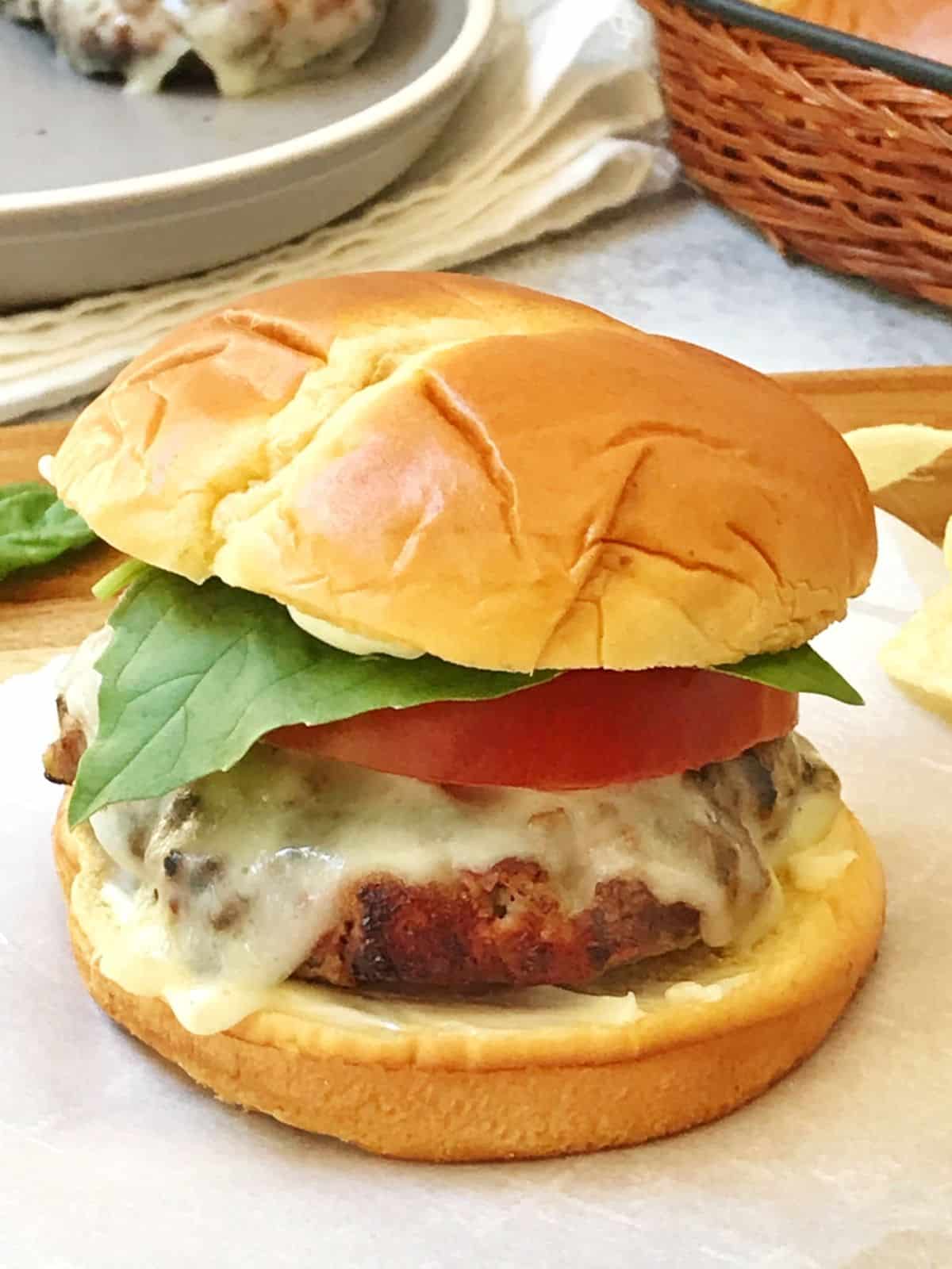 burger with cheese, tomato and basil