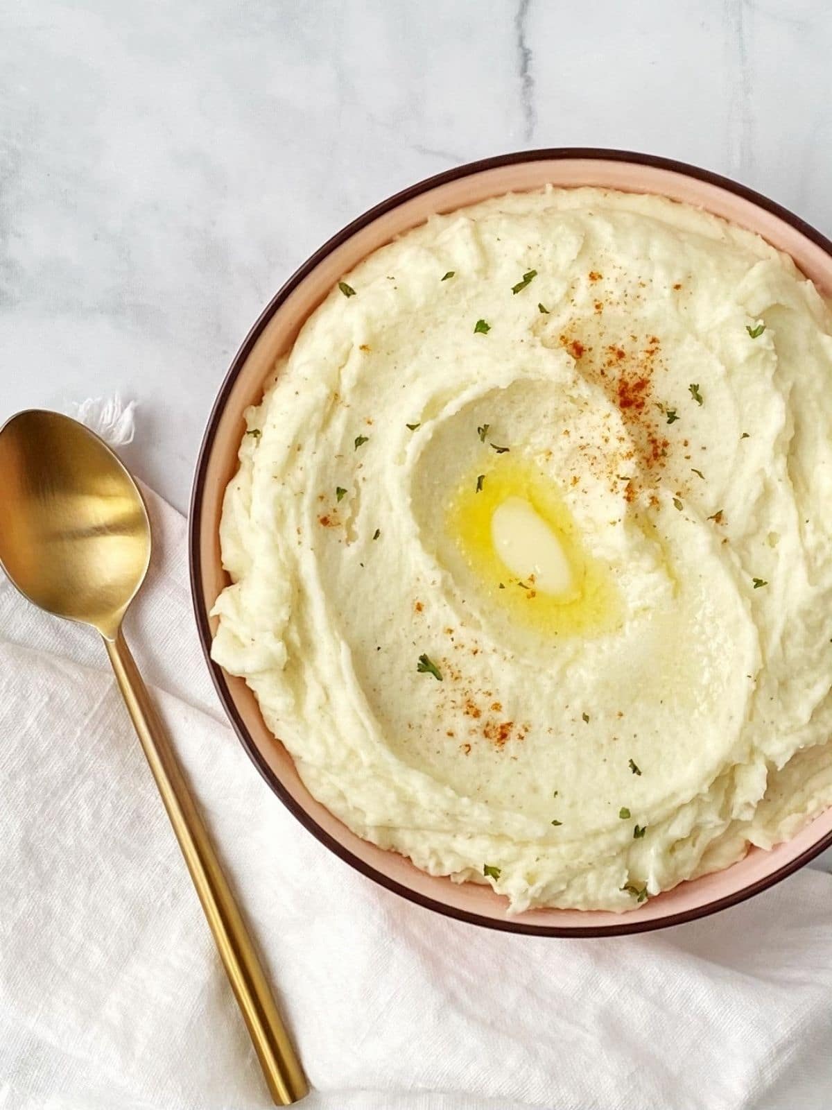 serving spoon next to bowl of mashed potatoes