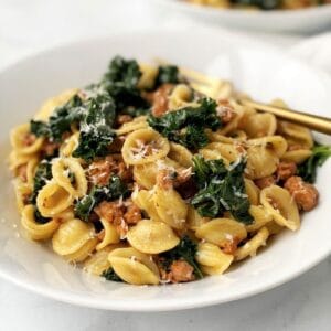 bowl of pasta with sausage and kale