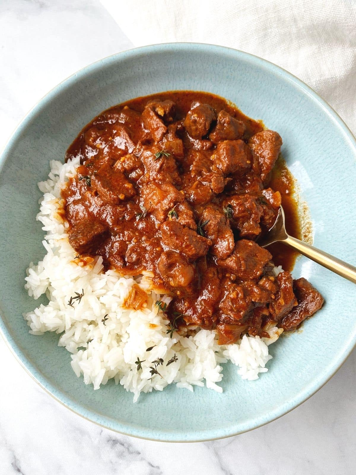 overhead shot of stew and rice in a bowl