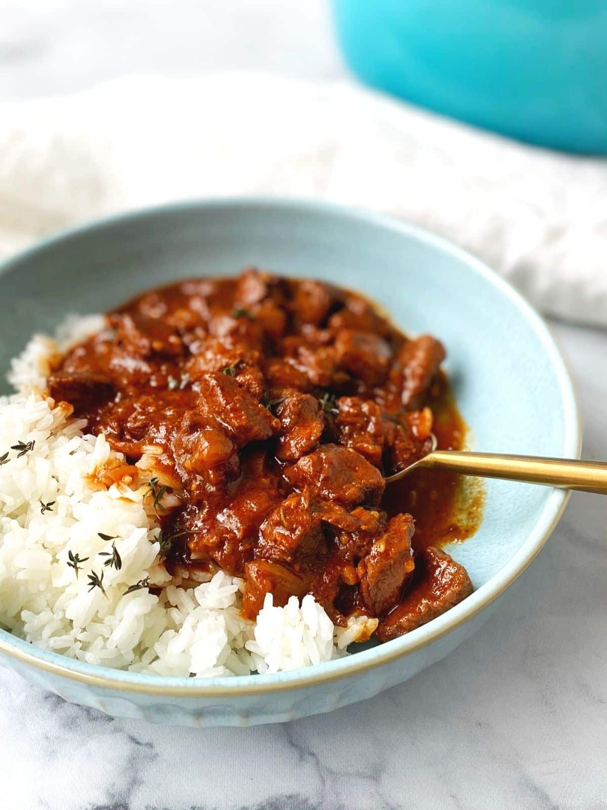 bowl of stew over rice