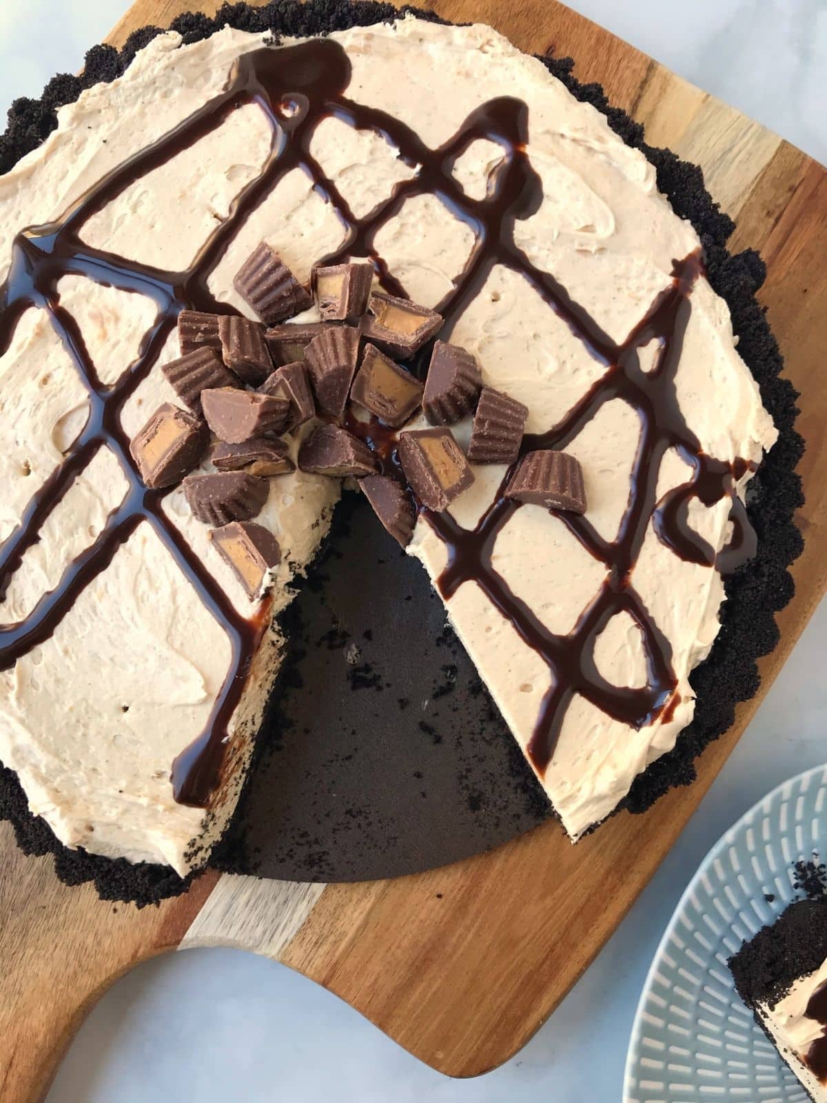 whole tart garnished with peanut butter cups and a slice removed