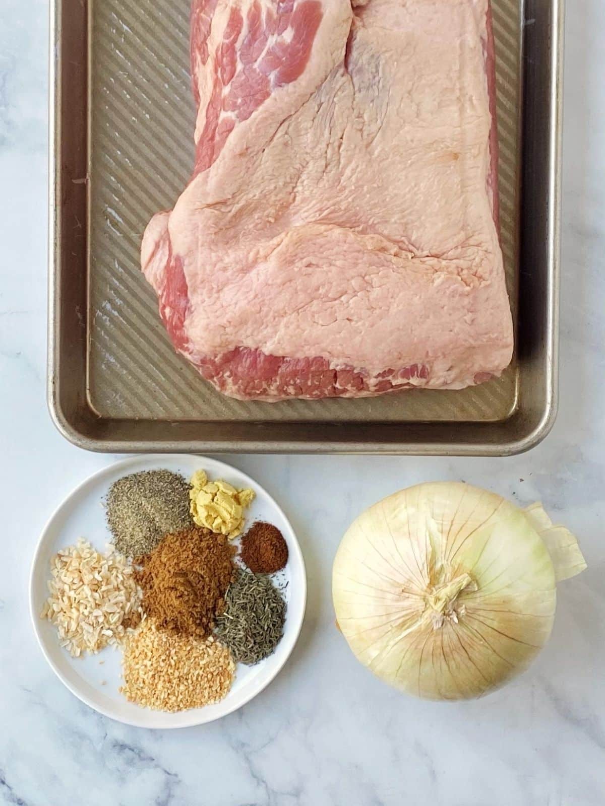 ingredients - corned beef brisket, spices, and onion