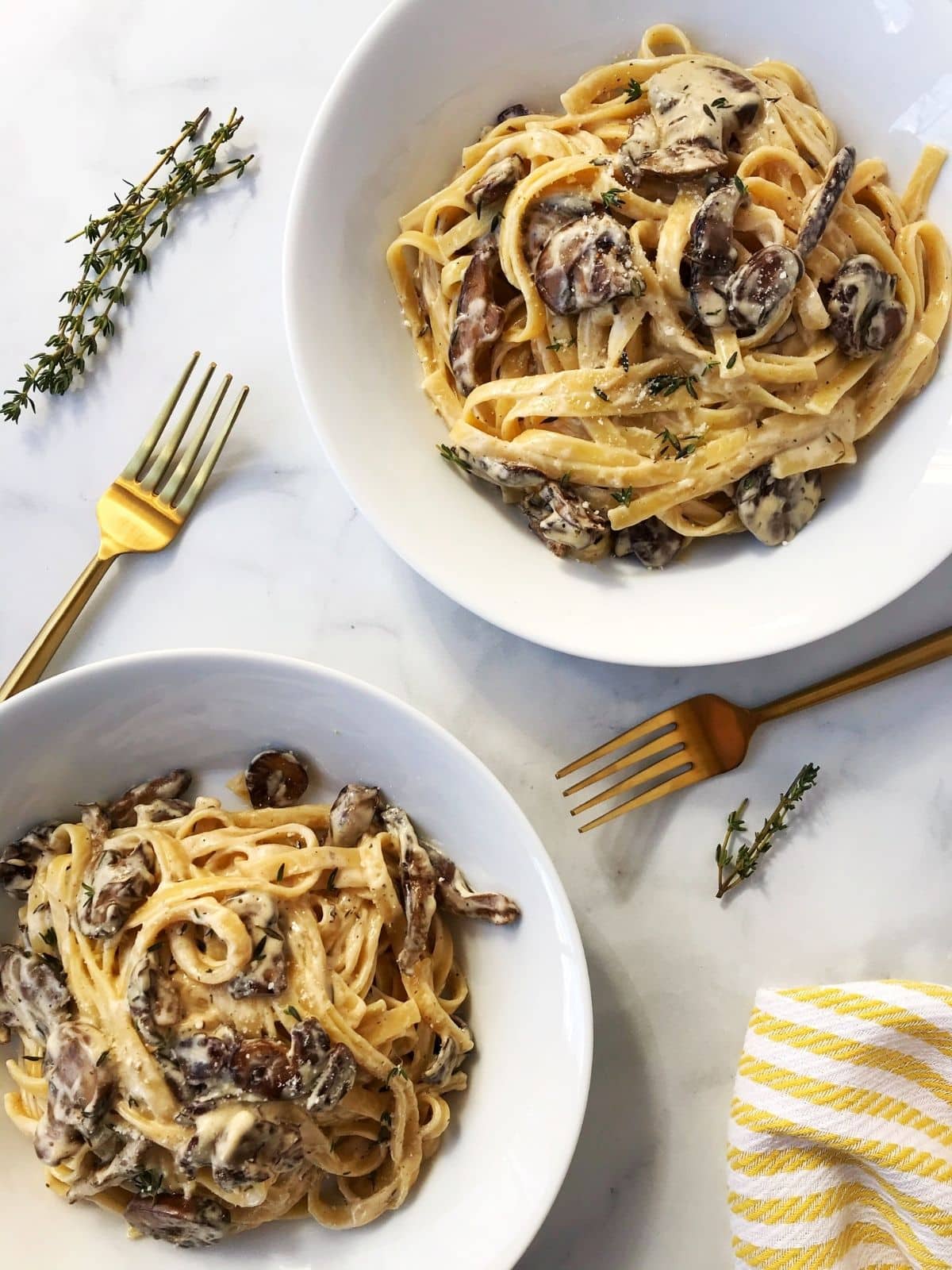 two bowls of pasta with mushrooms