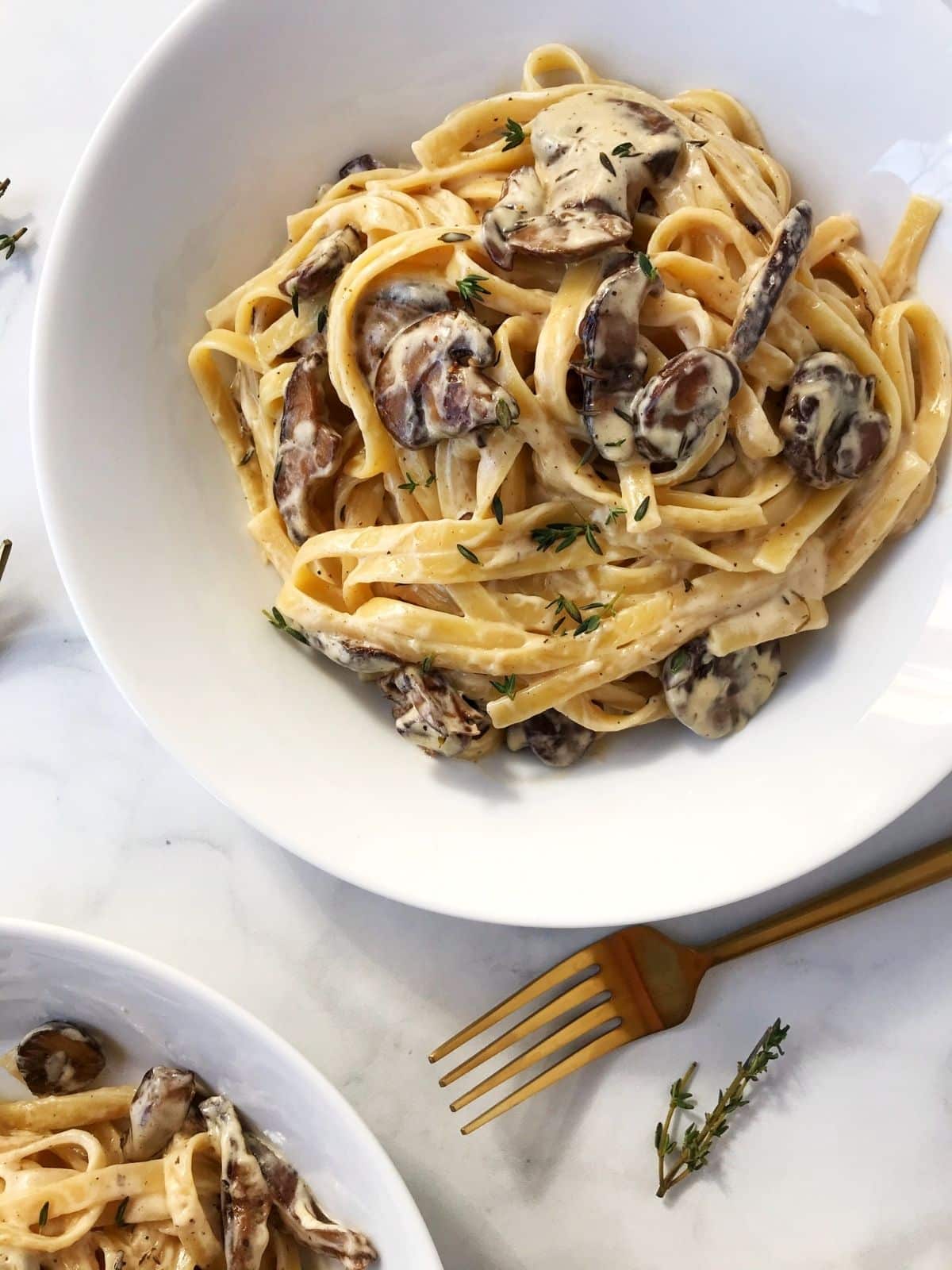 fork laying next to a bowl of pasta