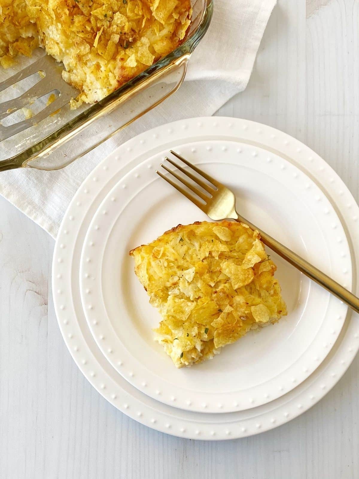 serving of potatoes on a plate next to casserole dish