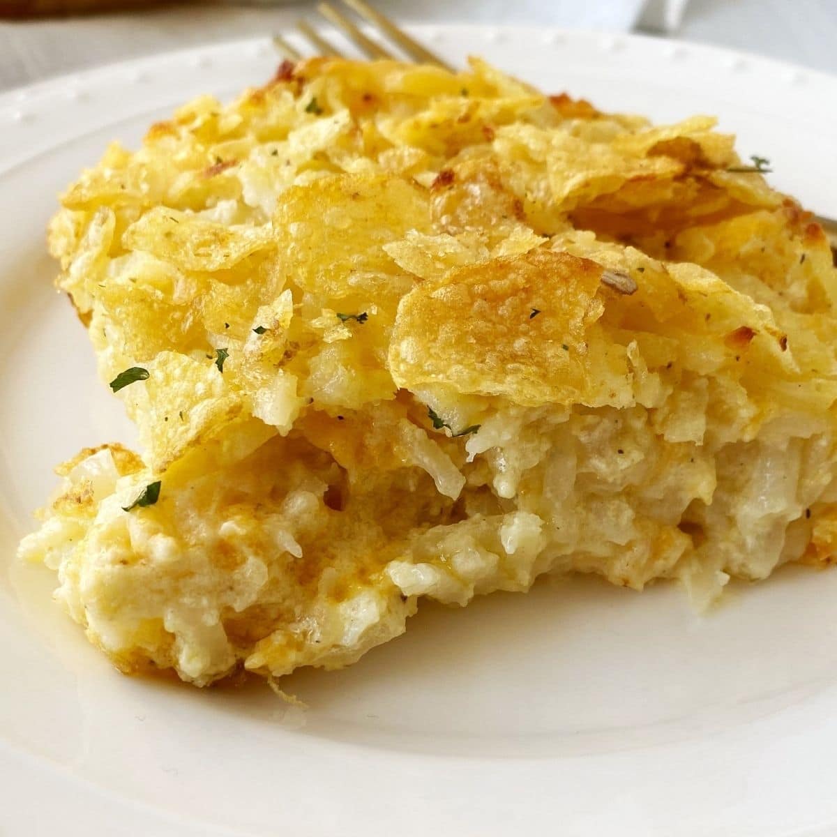 close up of serving of potato casserole on a plate