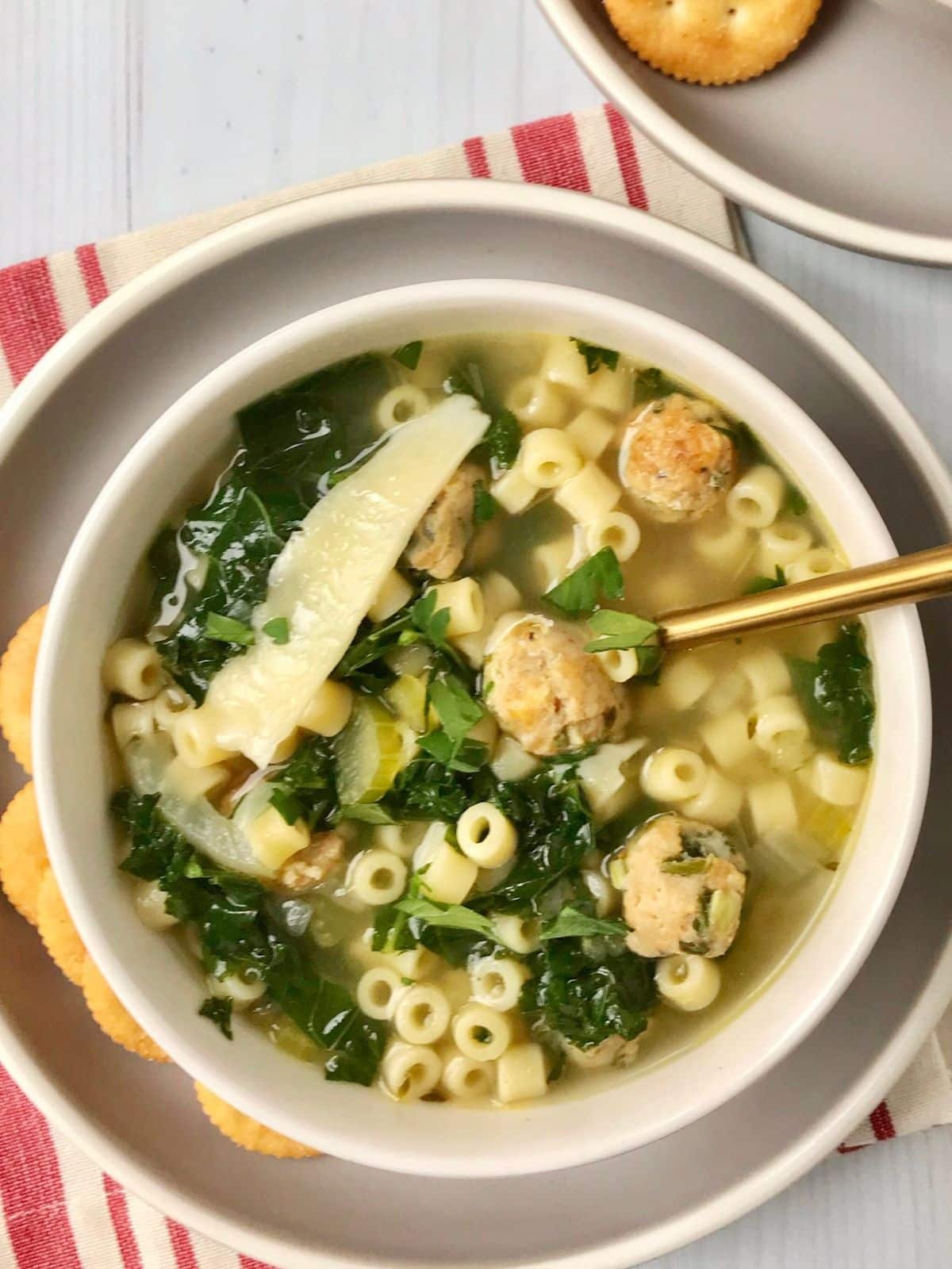 spoon in a bowl of soup with crackers