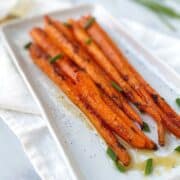 roasted carrots on a rectangular platter