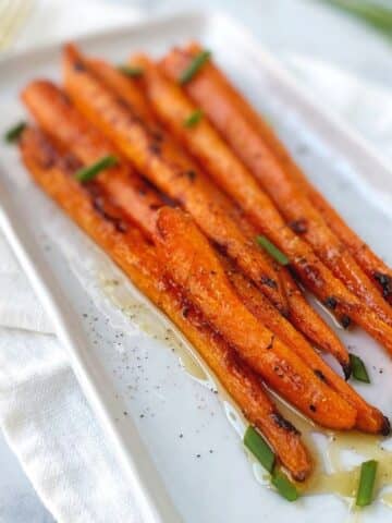 roasted carrots on a rectangular platter