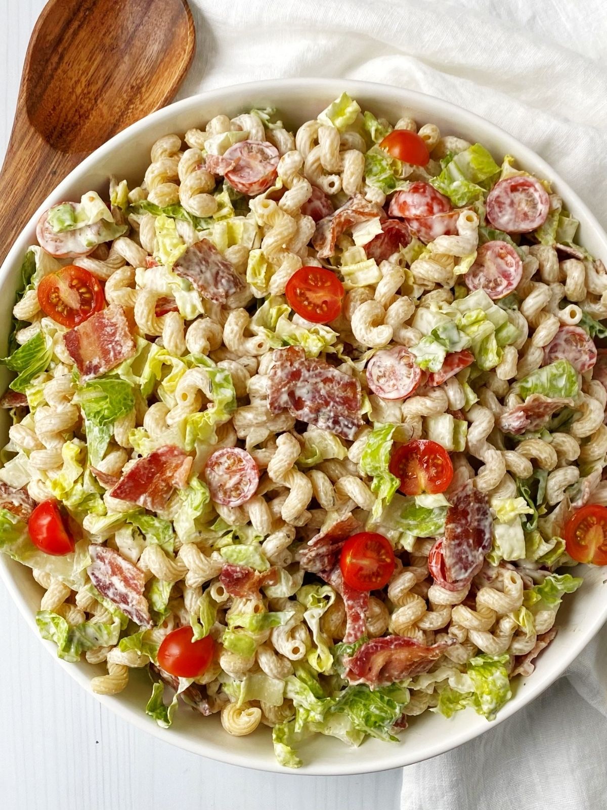 white serving bowl of pasta salad