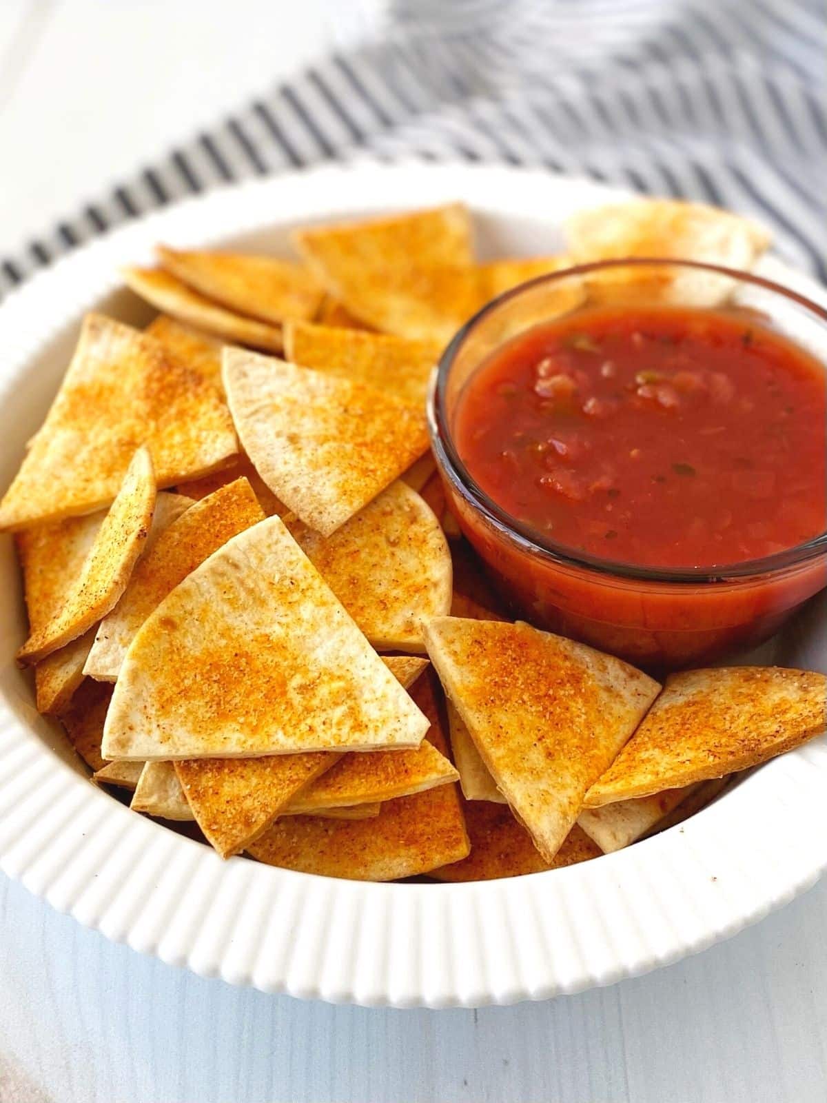 bowl of chips with dish of salsa