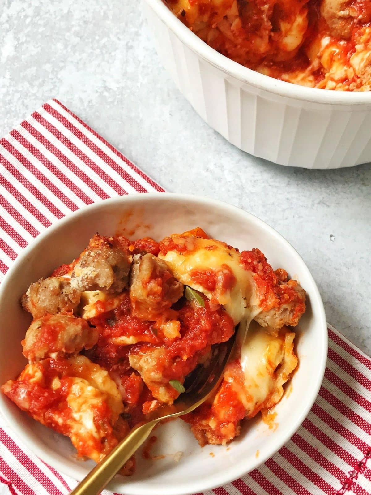 spoon in a bowl of sausage pasta