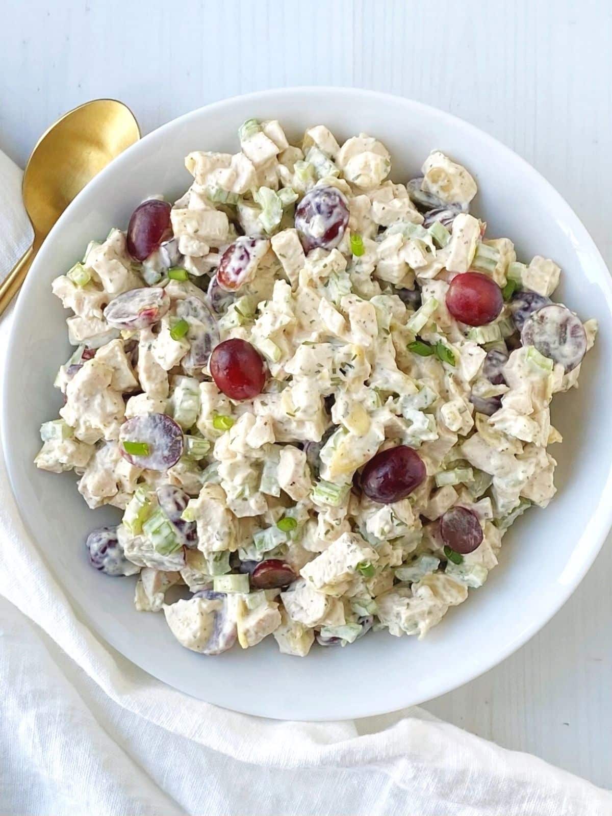 bowl of chicken salad with serving spoon