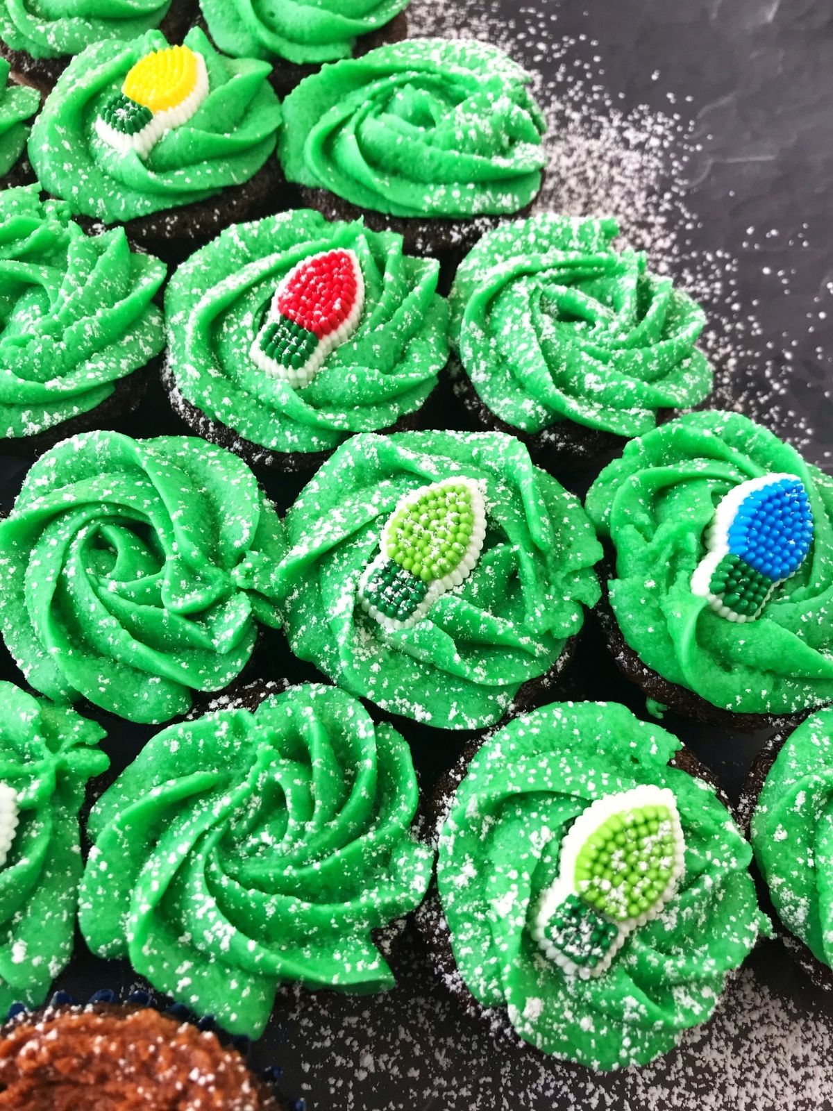 close up of green frosted cupcakes