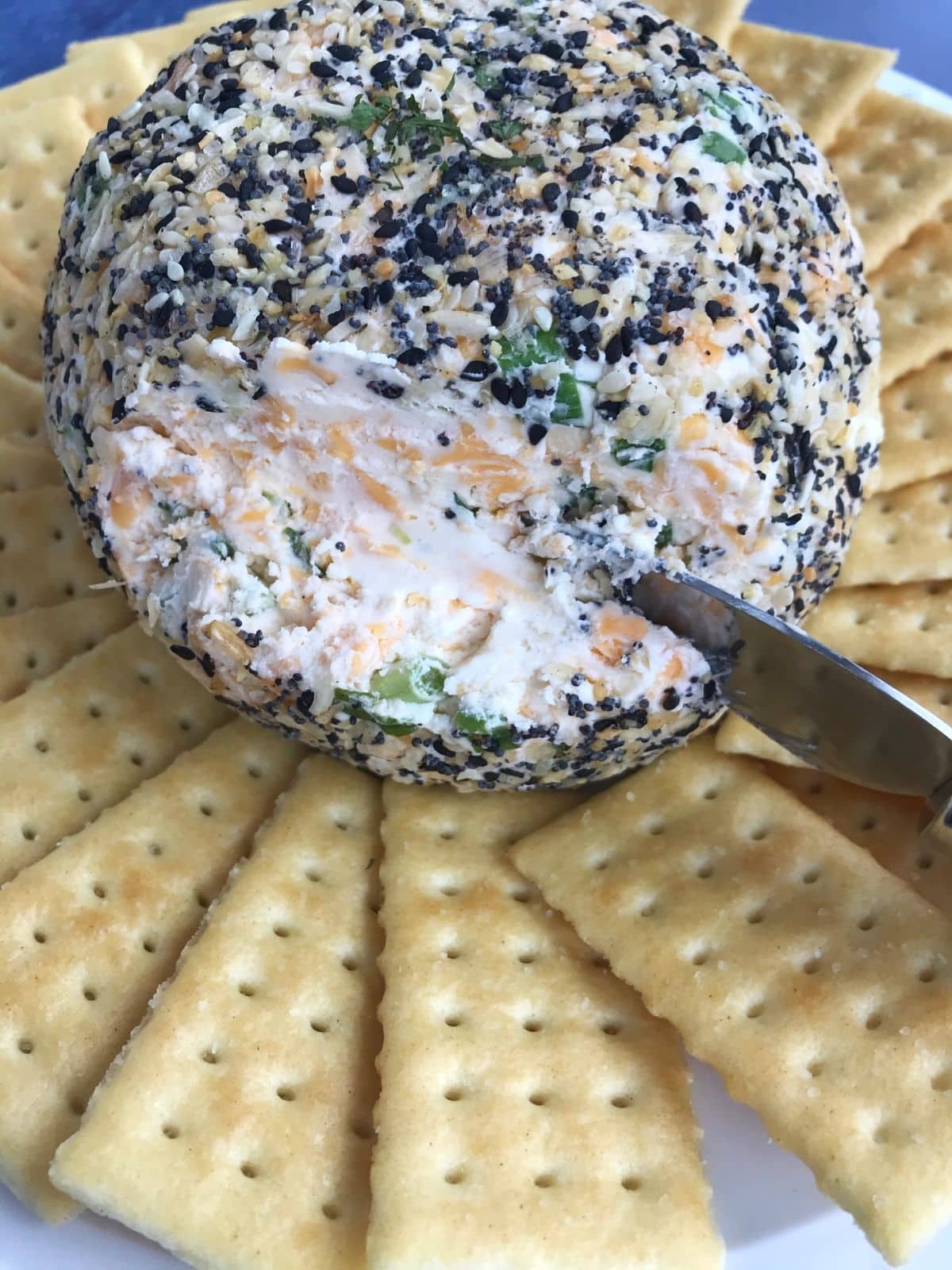 cheese knife scooping cheese ball