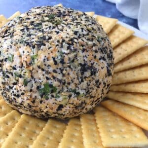 cheese ball on a plate with crackers