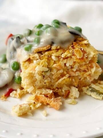 old fashioned salmon loaf topped with cream sauce on a plate