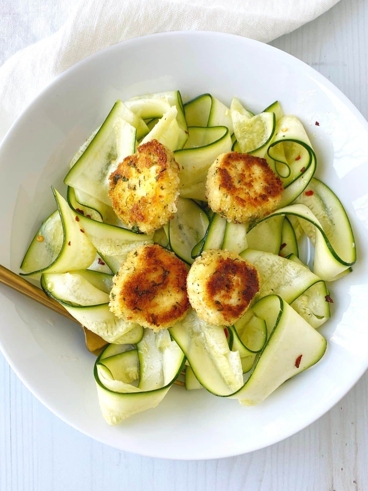 bowl of zucchini salad with warm goat cheese