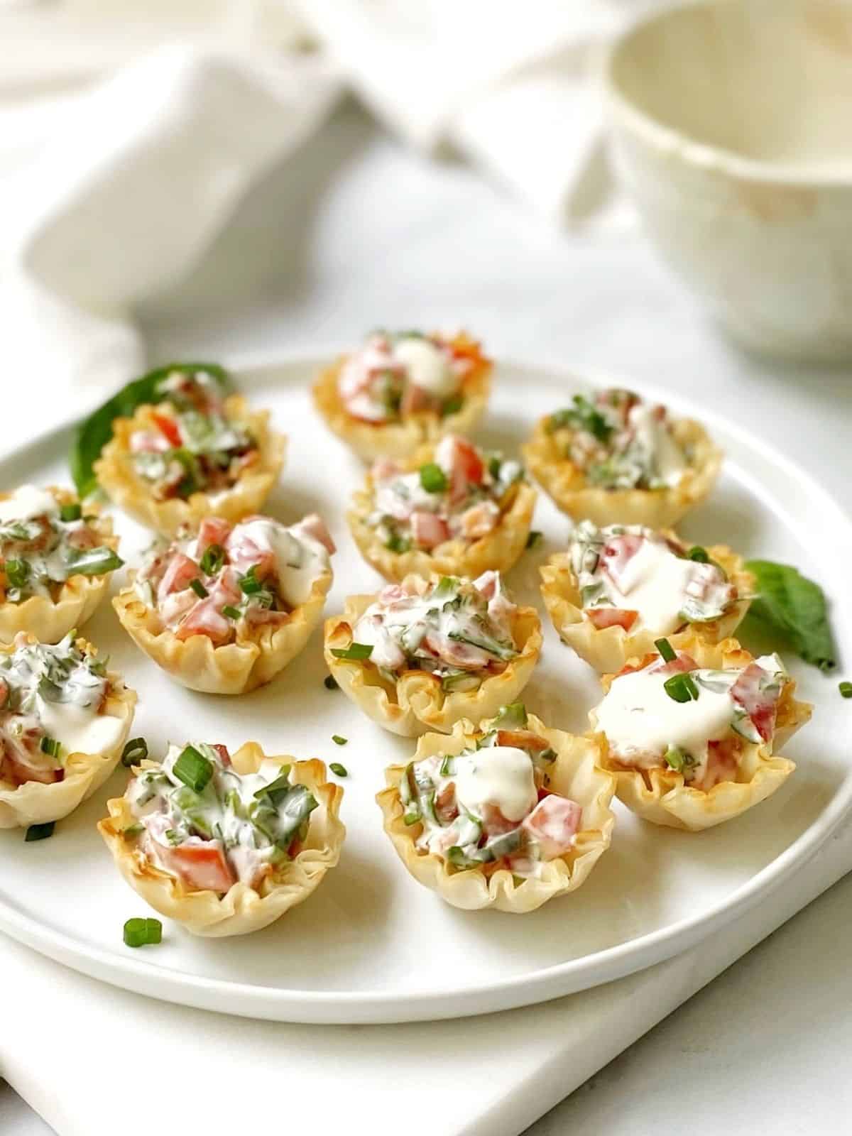 filled cups on a round white serving platter